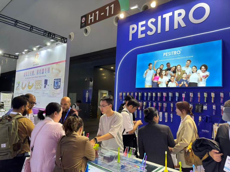 Visitors exploring PESITRO toothbrush displays at the blue DenTech China 2026 booth.